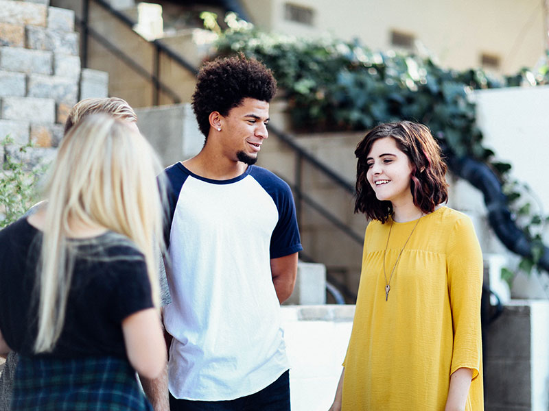 Boy and girls talking about best urban colleges
