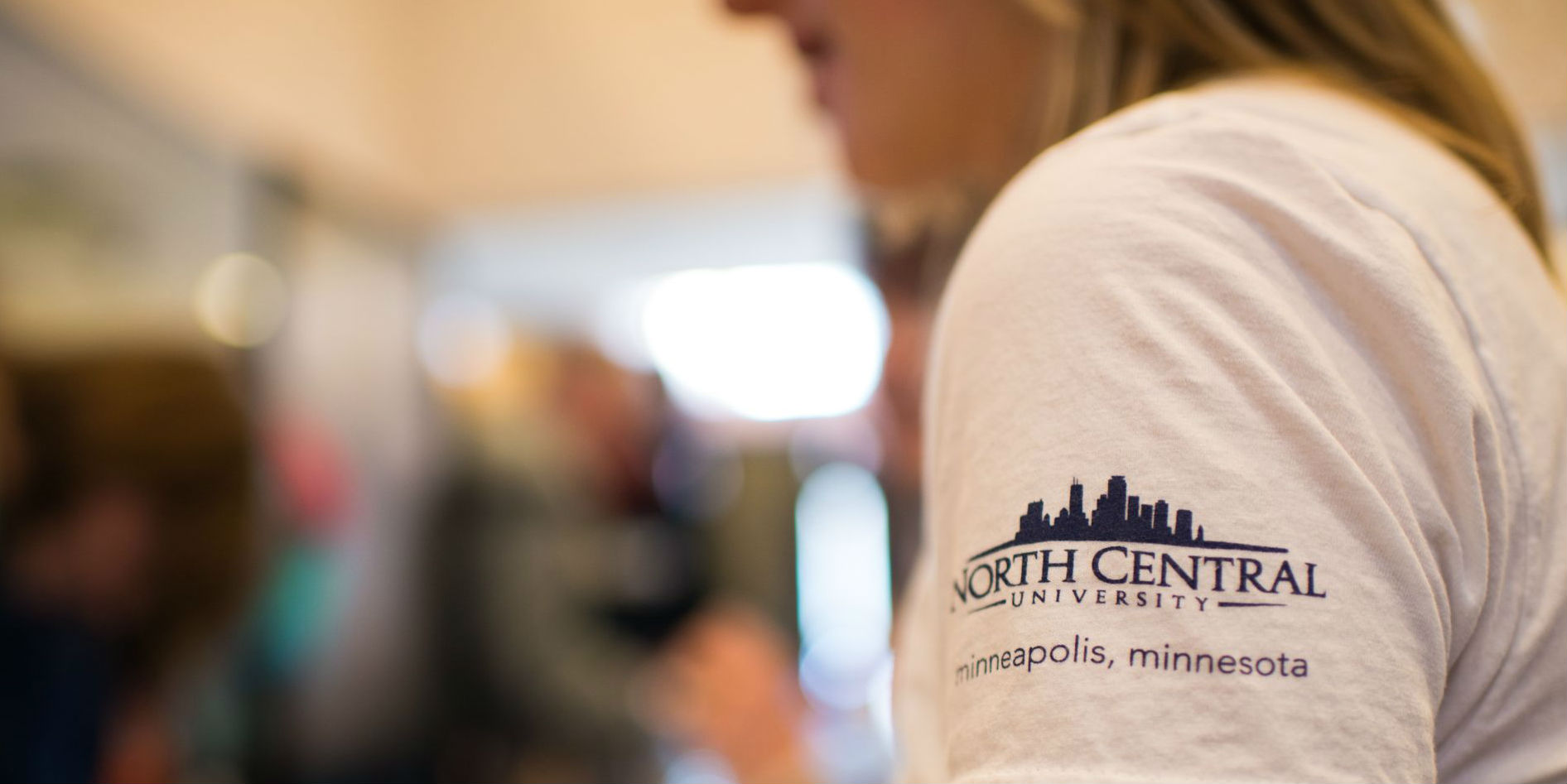 Close up shot of a North Central student wearing a school t-shirt.