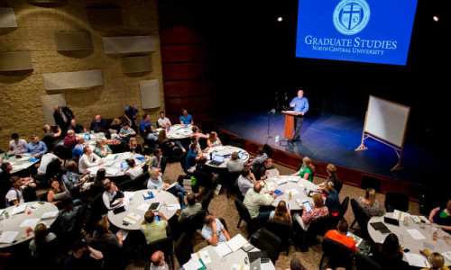 North Central president Dr. Gordon Anderson speaks at a gathering of graduate students.