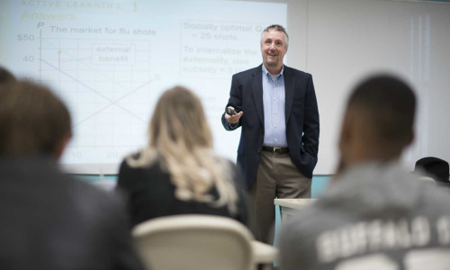 A business professor lectures business majors.