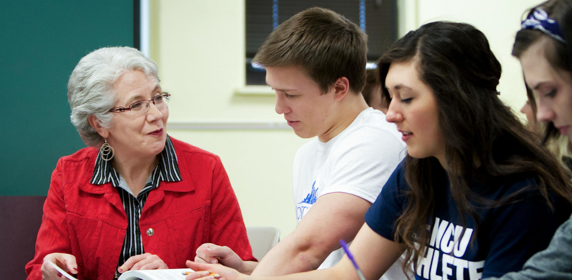 A professor works with students in the College of Arts & Sciences.