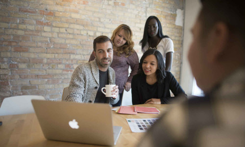 A group of North Central marketing students with a client.
