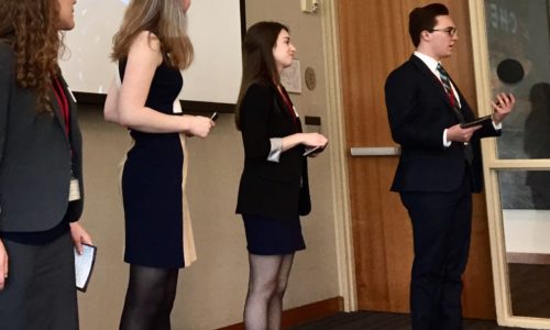 line up of students giving a presentation