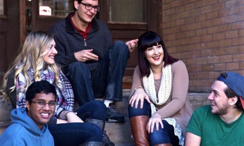 people laughing and talking on steps