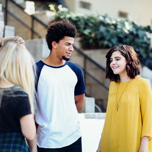 Boy and girls talking about best urban colleges