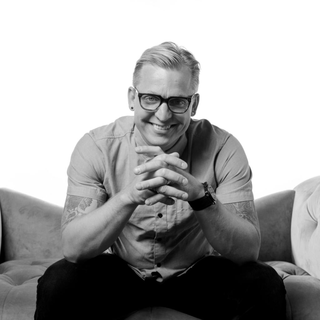 black and white photo of man folding hands