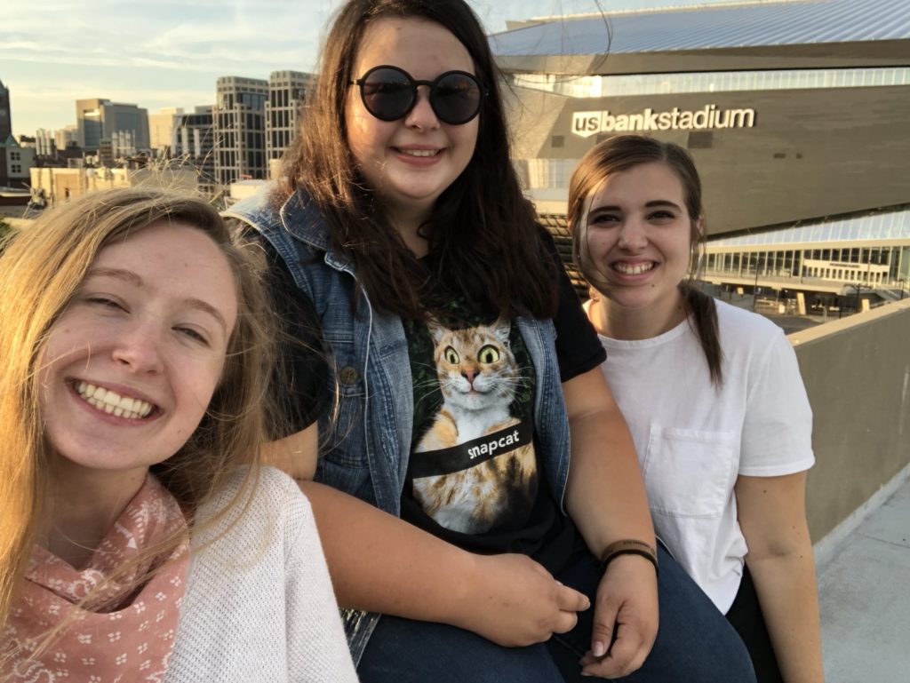 Three girls in front of US bank stadium