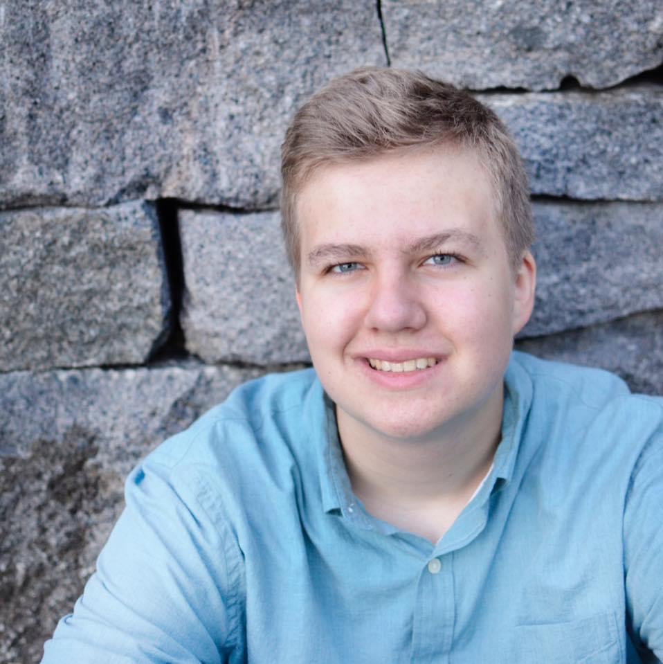 liben sitting in front of stone wall