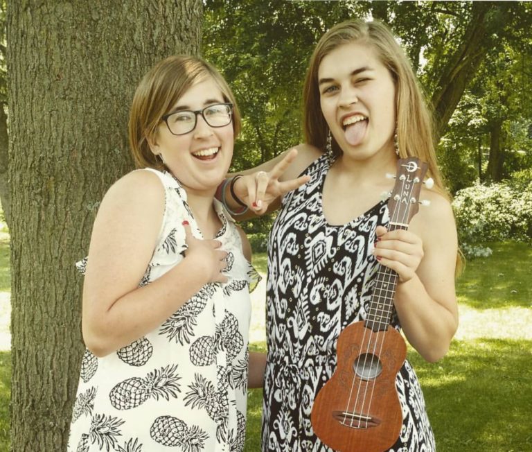 Two girls smiling with ukelele