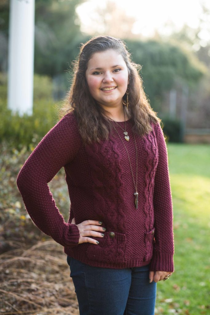 Tory wearing a maroon sweater