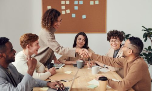 Six people greeting each other for a meeting with coffee