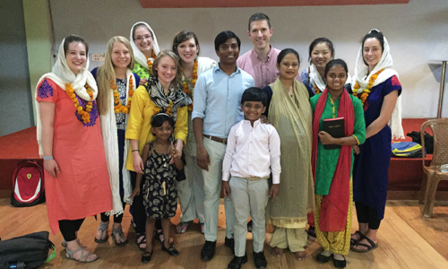 Group of people standing together in a church.