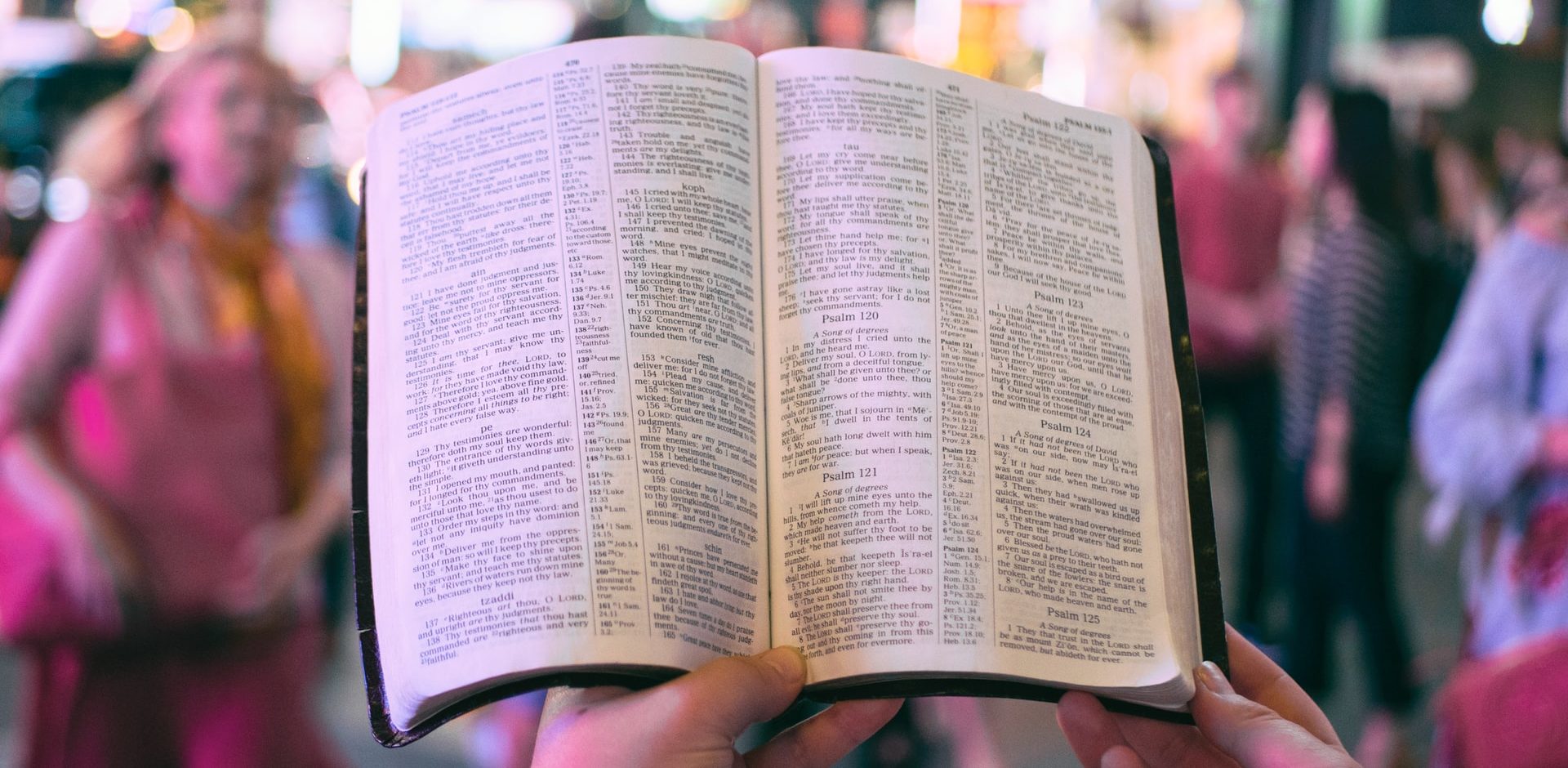Person in the city reading the bible
