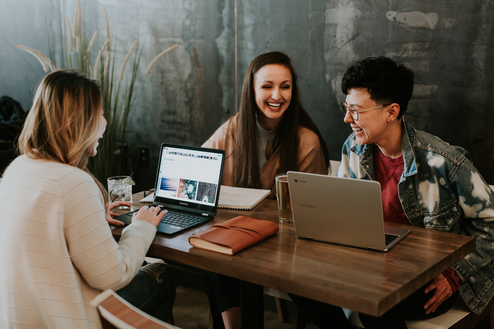Three people smiling and having a meeting