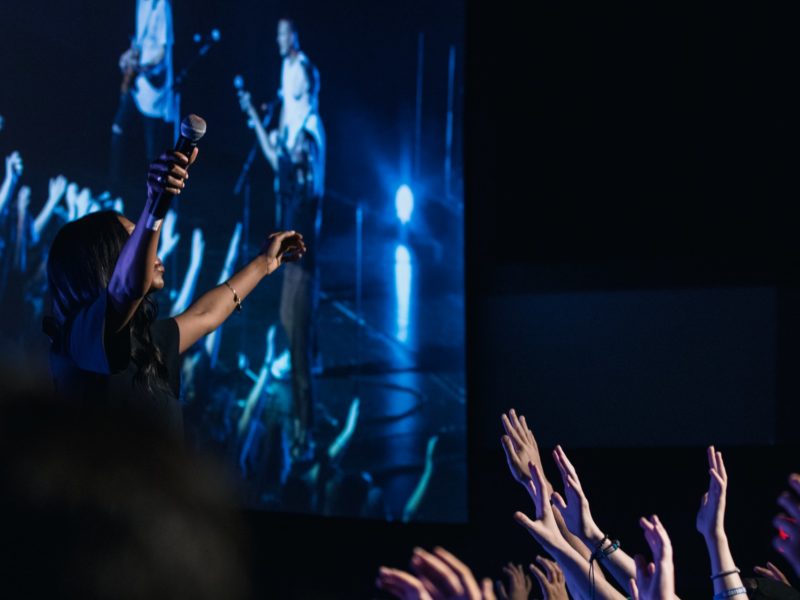 Group of people raising their hands worshipping