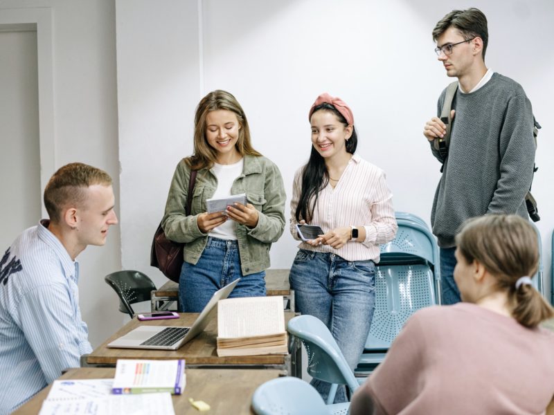 Five students talking in school