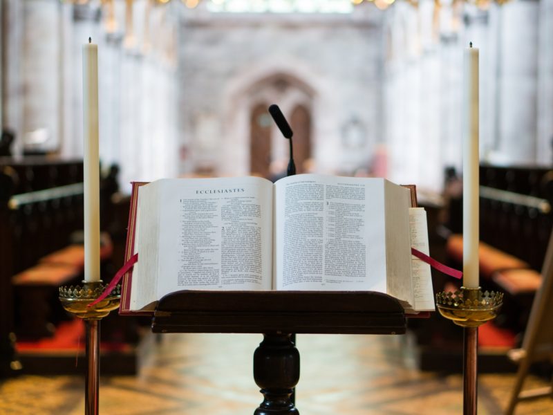 Ecclesiastes open in a church in between two candles