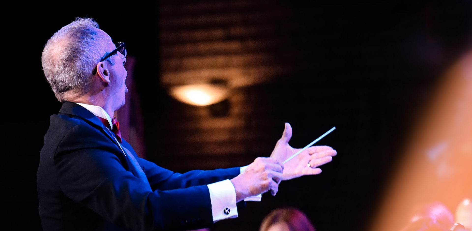 Photo of Larry Bach conducting NCU chorale