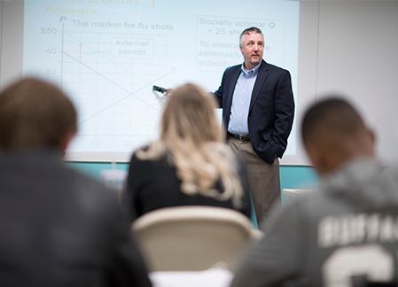 Shawn Sauve gives a lecture to several students