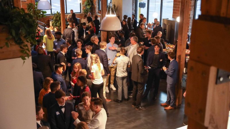 Crowd of students in business attire networking