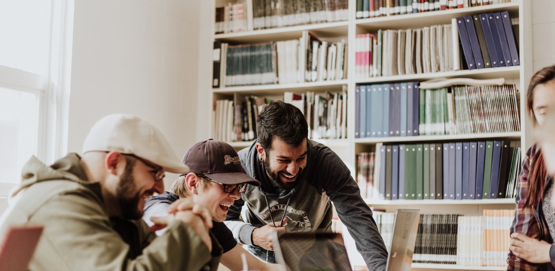 Students laughing in front of computers