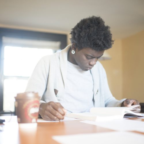 A student sits at a desk and studies