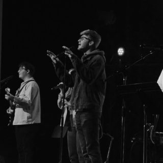 Logan leads worship during a live performance