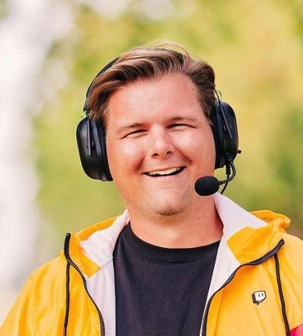 Grant Diamond is wearing a headset and smiling at the camera