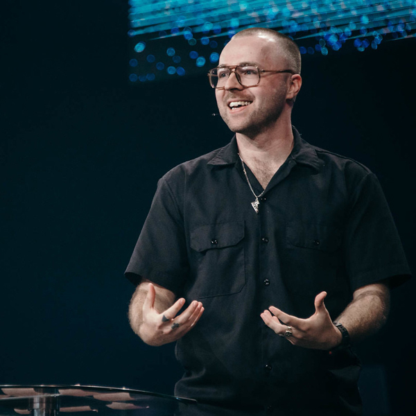 Jon Rush smiles while speaking on-stage