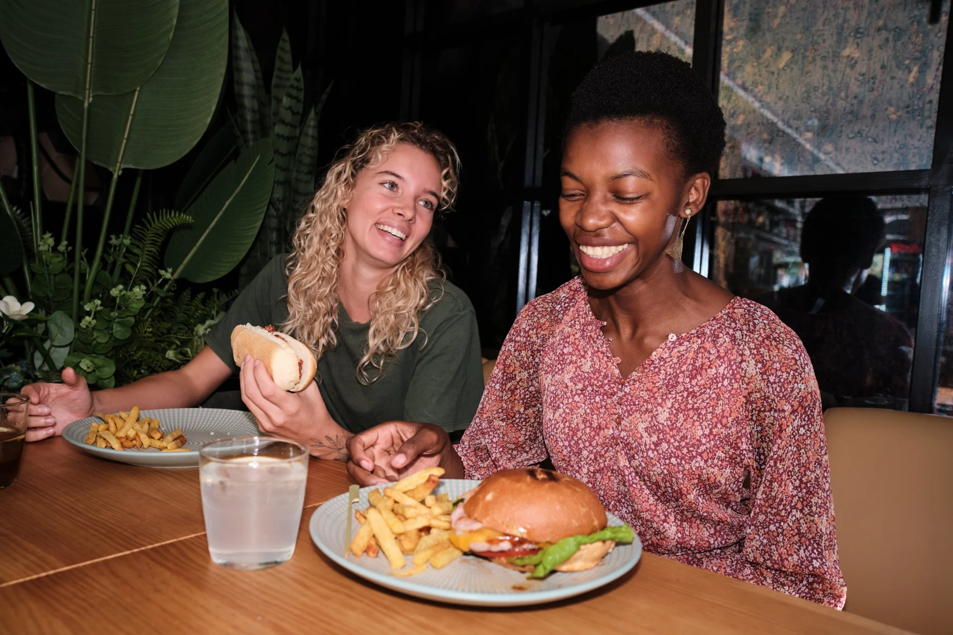 College students sharing a meal and laughing together at a local diner table