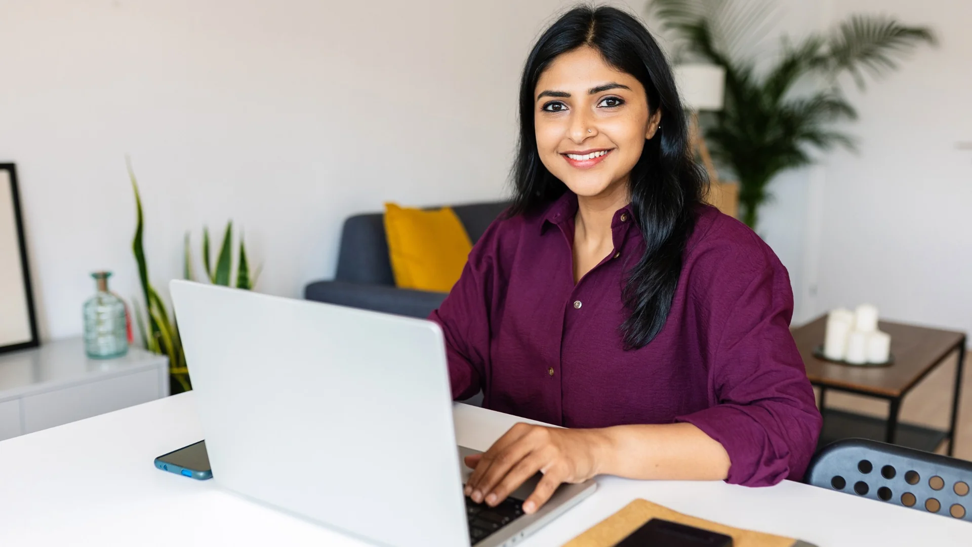 Student working on laptop at home office